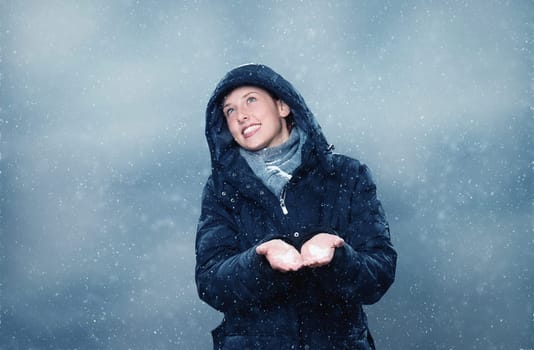 Young woman is happy that it snows