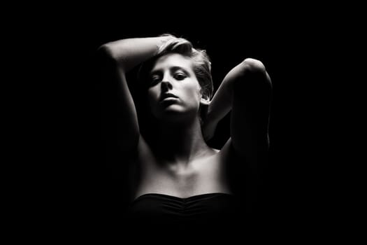 Portrait of a young woman in exciting light in black and white