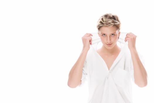 Young woman holds her shirt collar on white background