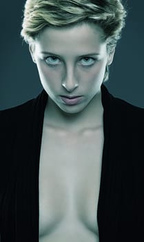 Portrait of a beautiful young woman with an open black shirt