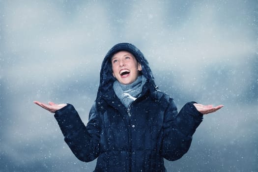 Young woman is excited about snowfall