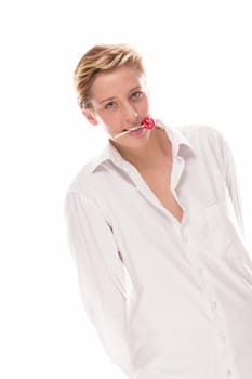 Young woman holds lollipops across her mouth on a white background