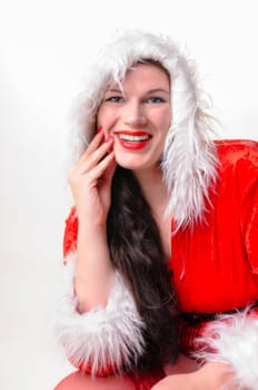 Portrait of an adult woman with long dark hair. She wears a red Christmas coat with a white fur collar,exposed against a white background.