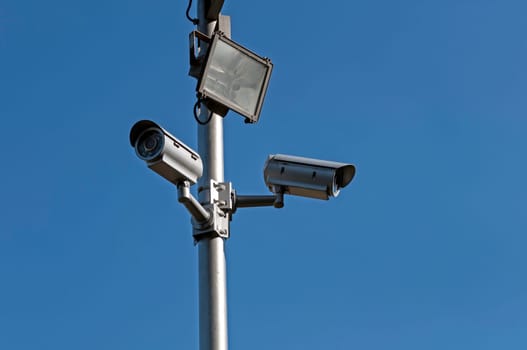 Crime control. Two security cameras monitor a parking lot.
