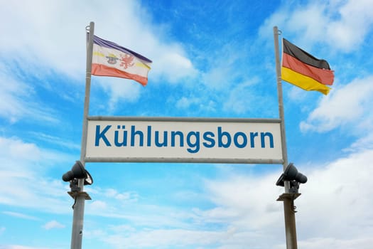 Pier sign at the end of the bridge of kuehlungsborn with german flag