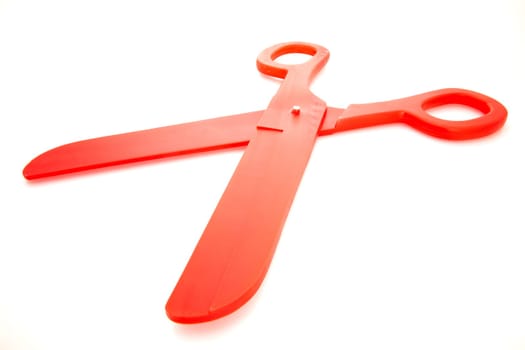 A pair of big plastic red scissors