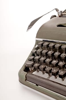 A military green old mechanical typewruter on a white backround