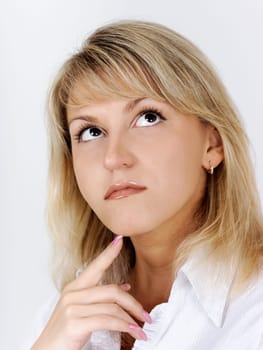 Portrait of a beautiful attractive blonde in a white blouse