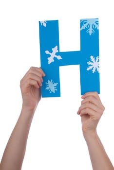Two Hands Holding the Blue and Snowy Letter H, Isolated