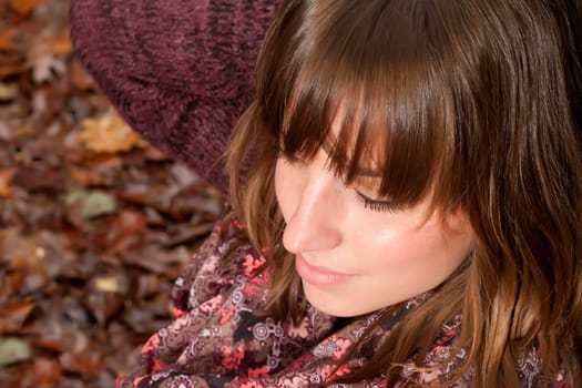 Young woman in the autumn at a cold november day