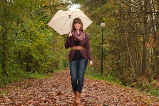 Young woman in the autumn at a cold november day