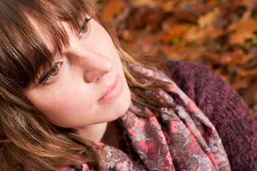 Young woman in the autumn at a cold november day