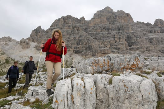 Young mountaineers hike in the mountains Alps Dolomites