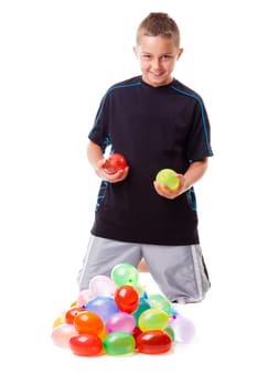 Boy with a pile of water balloons isolated on white background