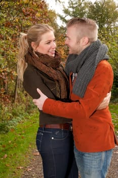 Happy young couple is having a nice time in october