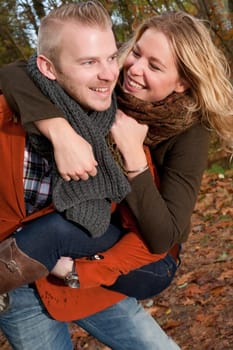 Happy young couple is having a nice time in october