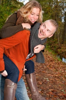 Happy young couple is having a nice time in october