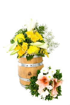 Bouquet of flowers on and next to a small wooden barrel