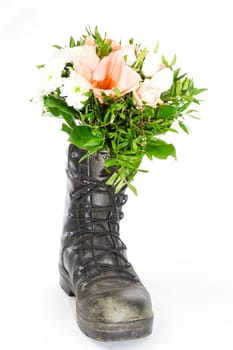 An old boot with a bouquet of flowers