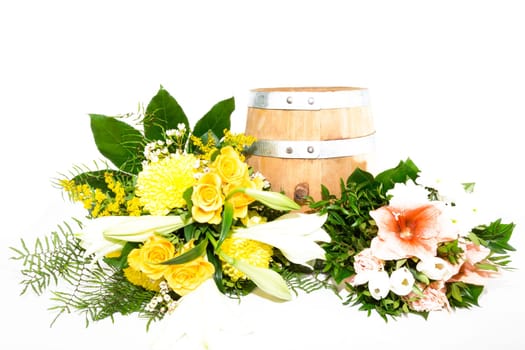 Bouquet of flowers on and next to a small wooden barrel