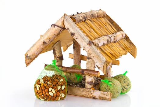 Birdhouse with bird food on a light background