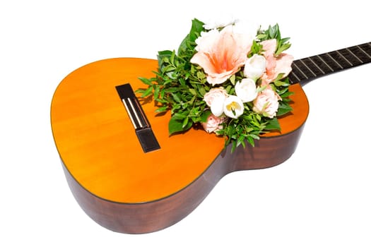A bouquet of flowers is in a guitar