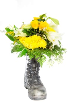 An old boot with a bouquet of flowers