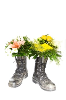 Two old boots with a bouquet of flowers