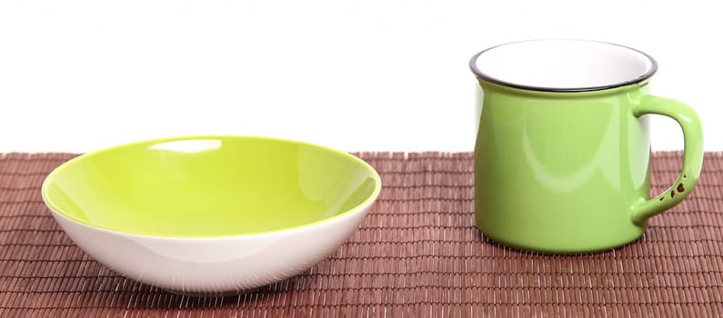 A green broken-down cup and bowl, empty, isolated