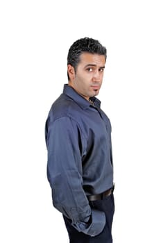 A young man standing for white background very relaxed with his.hands in his pocket..