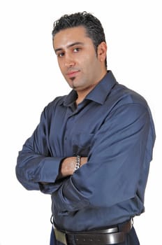A young tall man standing for white background very relaxed with his.arms crossed..