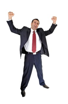 A tall handsome businessman standing for white background in a blue .suit and red tie lifting up his arms for happiness..