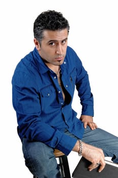 A young man in a blue white shirt sitting whit a book in his hand.looking into the camera and thinking, for white background..