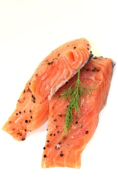 two raw salmon pieces with dill