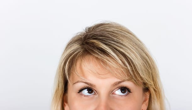 women's eyes peek out from behind framework