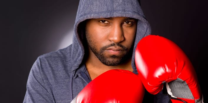 African Anerican male boxer poses for a boxing portrait