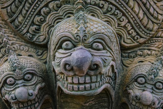 Stone statue on the wall of the temple in Thailand.