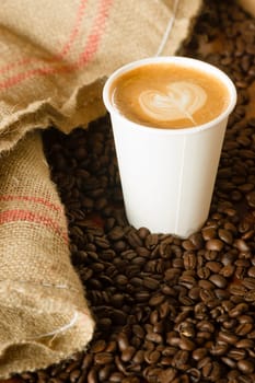 Cup of Coffee on the Counter with Roasted Beans