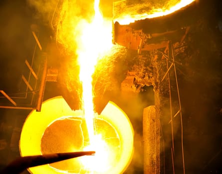 Molten hot steel pouring.