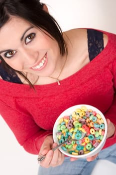 Female sits cross legged eating cereal in milk