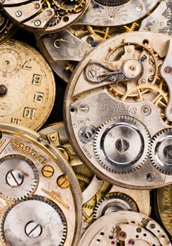 Vintage time pieces lay in a pile needing repair