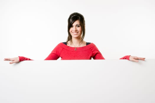 Woman smiles at she stands in between white spaces