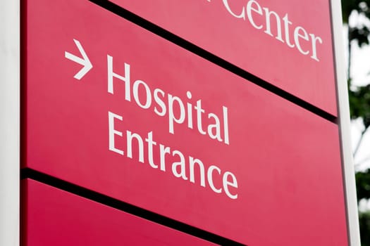 Red sign indicating hospital entrance outside