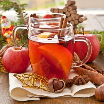 Hot drink for Christmas with cinnamon and oranges