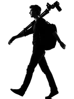 young man photographer silhouette in studio isolated on white background