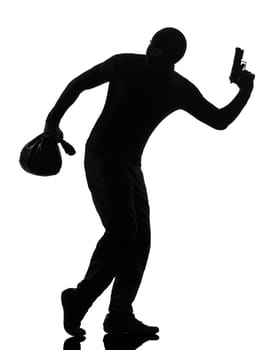 thief criminal holding gun in silhouette studio isolated on white background