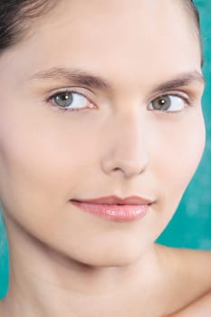 studio shot beauty portrait of a beautiful green eyes caucasian young woman on a blue background