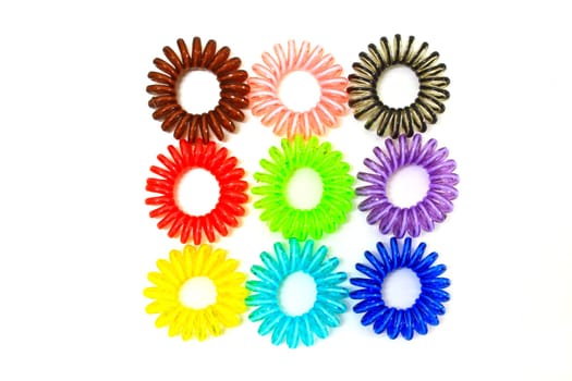 Spiral colorful elastic hair ties used on a white background.