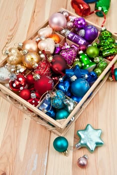 Small box with colorful Christmas tree baubles for Christmas