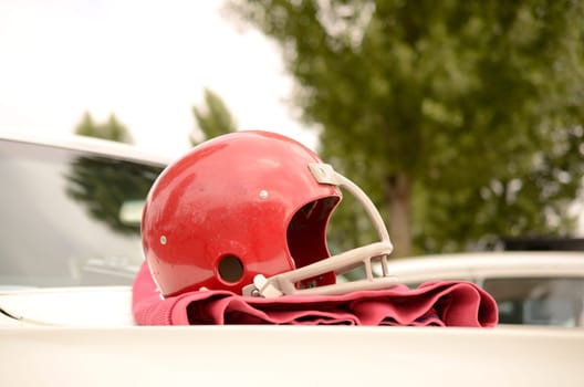 Football helmet on an American vintage car
